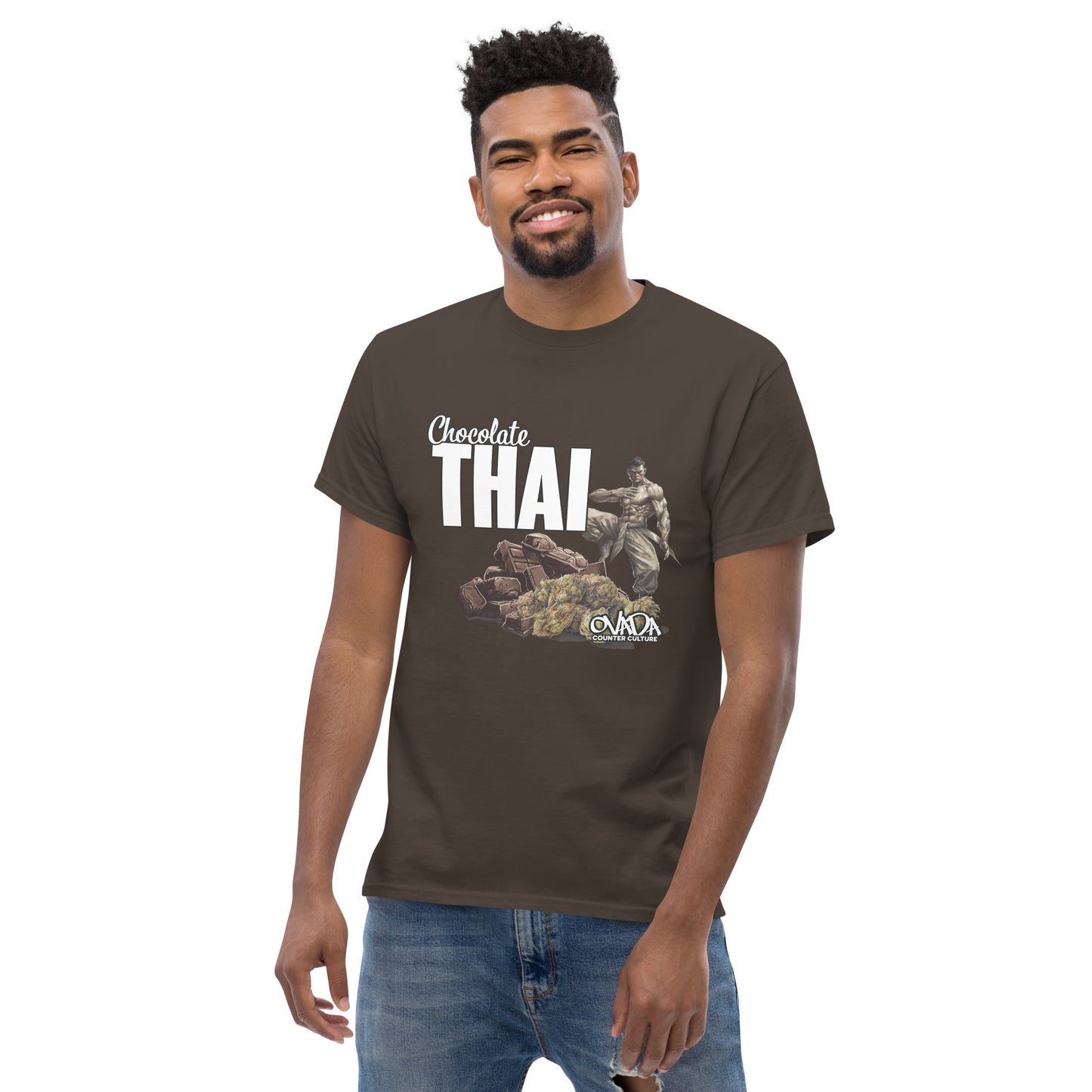 A man in a dark brown cotton graphic t-shirt with the words Chocolate Thai. A cartoon depiction of a Muay Thai Fighter is standing on a pile of chocolates, with marijuana buds in front of it.