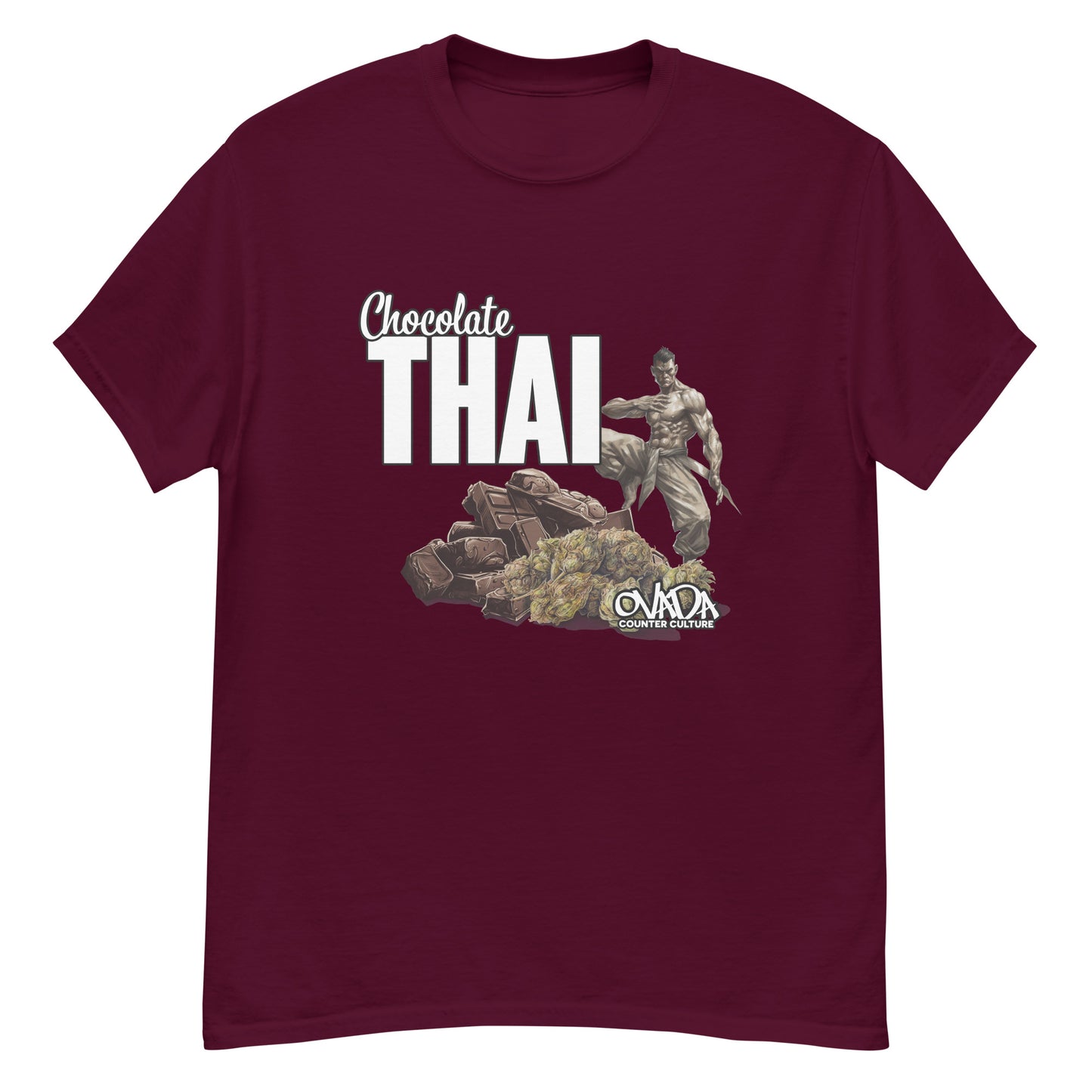 A maroon cotton graphic t-shirt with the words Chocolate Thai. A cartoon depiction of a Muay Thai Fighter is standing on a pile of chocolates, with marijuana buds in front of it.