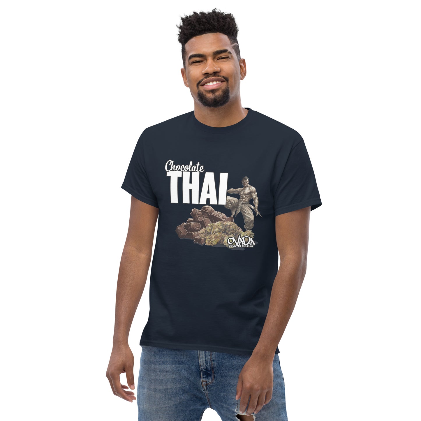 A man in a navy blue cotton graphic t-shirt with the words Chocolate Thai. A cartoon depiction of a Muay Thai Fighter is standing on a pile of chocolates, with marijuana buds in front of it.