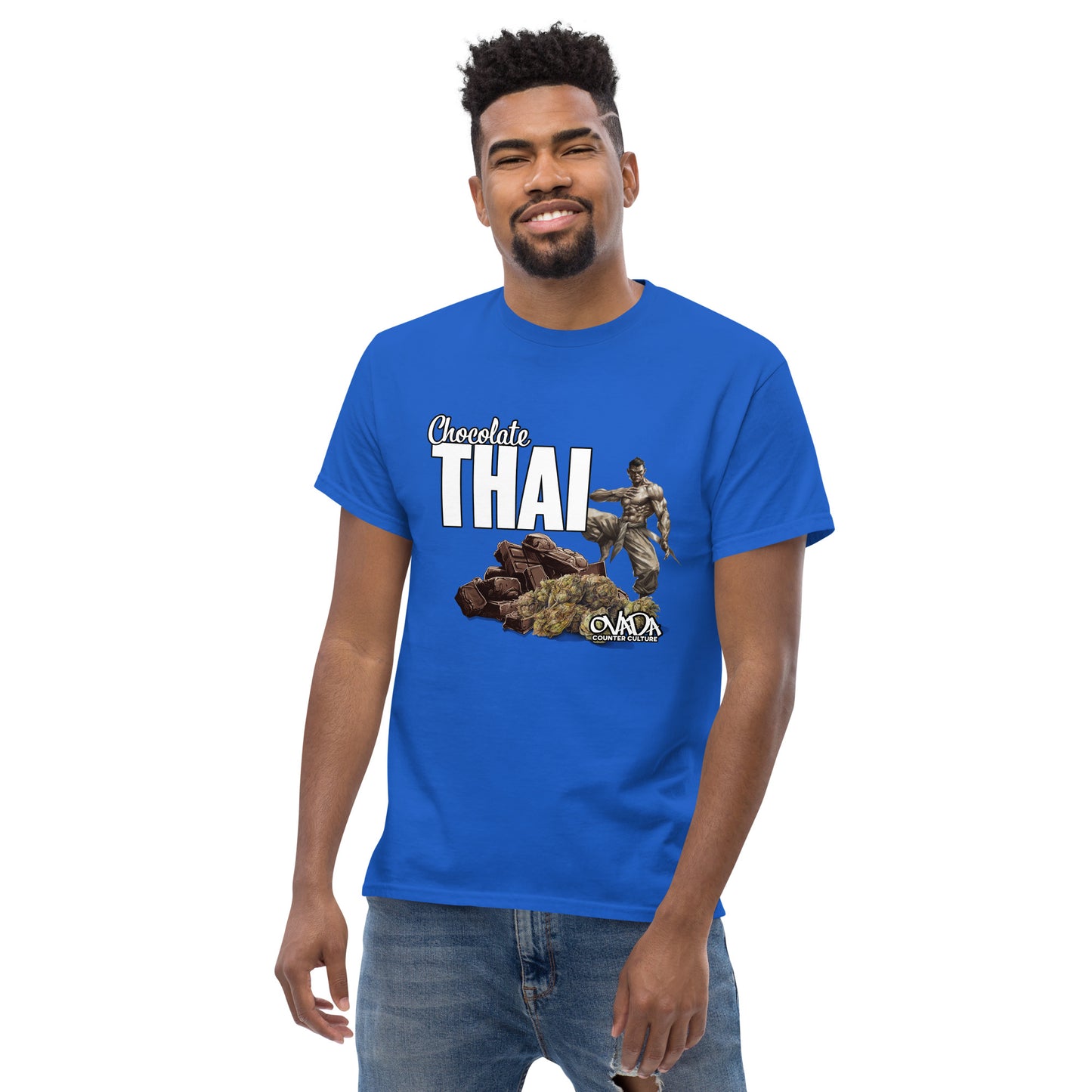 A man in a royal blue cotton graphic t-shirt with the words Chocolate Thai. A cartoon depiction of a Muay Thai Fighter is standing on a pile of chocolates, with marijuana buds in front of it.