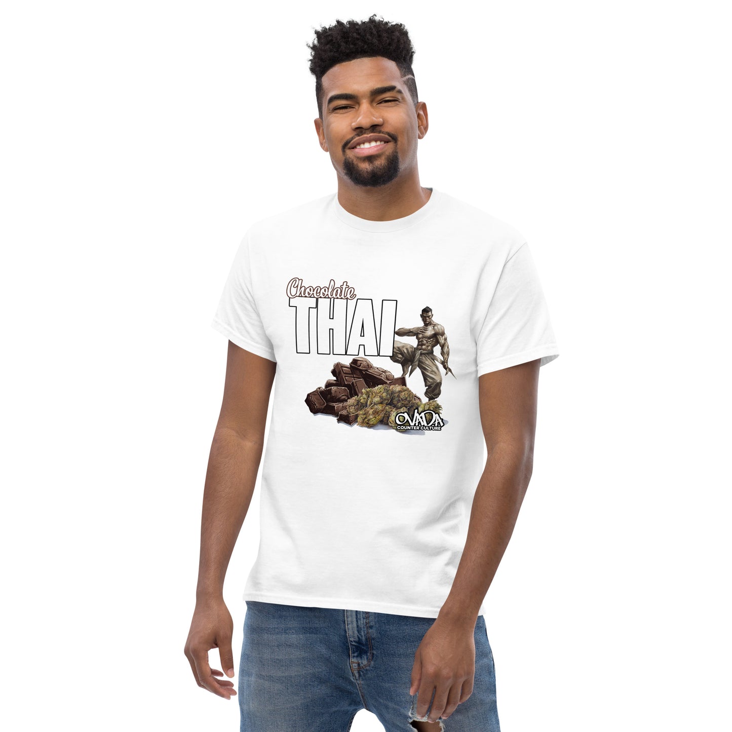 A man in a white cotton graphic t-shirt with the words Chocolate Thai. A cartoon depiction of a Muay Thai Fighter is standing on a pile of chocolates, with marijuana buds in front of it.