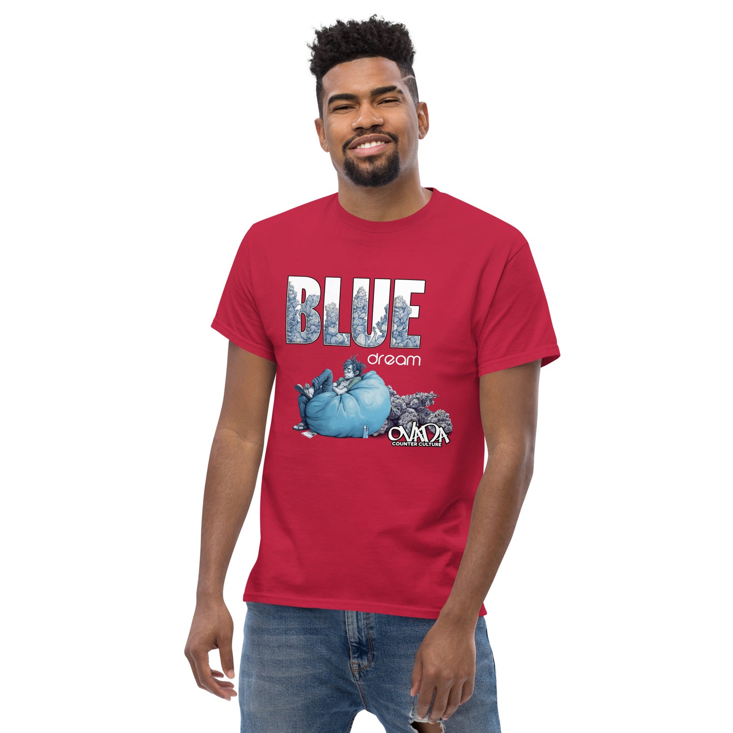 A man in a red cotton graphic t-shirt with the words Blue Dream. A monochromatic blue cartoon depiction of a stoner passed out in a bean back with marijuana buds behind him. Weed