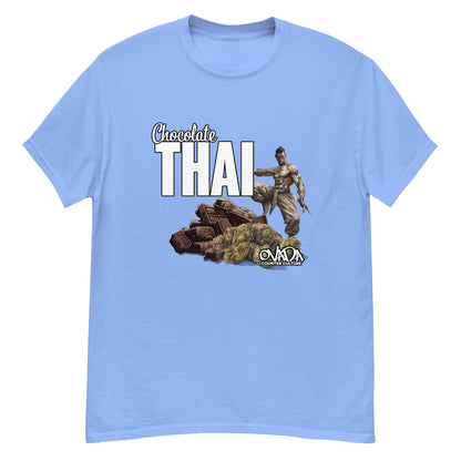 A Carolina blue cotton graphic t-shirt with the words Chocolate Thai. A cartoon depiction of a Muay Thai Fighter is standing on a pile of chocolates, with marijuana buds in front of it. 