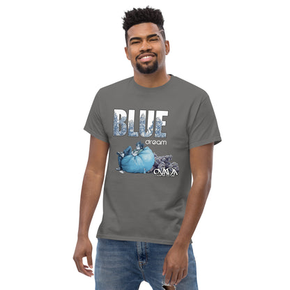 A man in a charcoal cotton graphic t-shirt with the words Blue Dream. A monochromatic blue cartoon depiction of a stoner passed out in a bean back with marijuana buds behind him. Weed