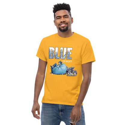 A man in a gold cotton graphic t-shirt with the words Blue Dream. A monochromatic blue cartoon depiction of a stoner passed out in a bean back with marijuana buds behind him. Weed