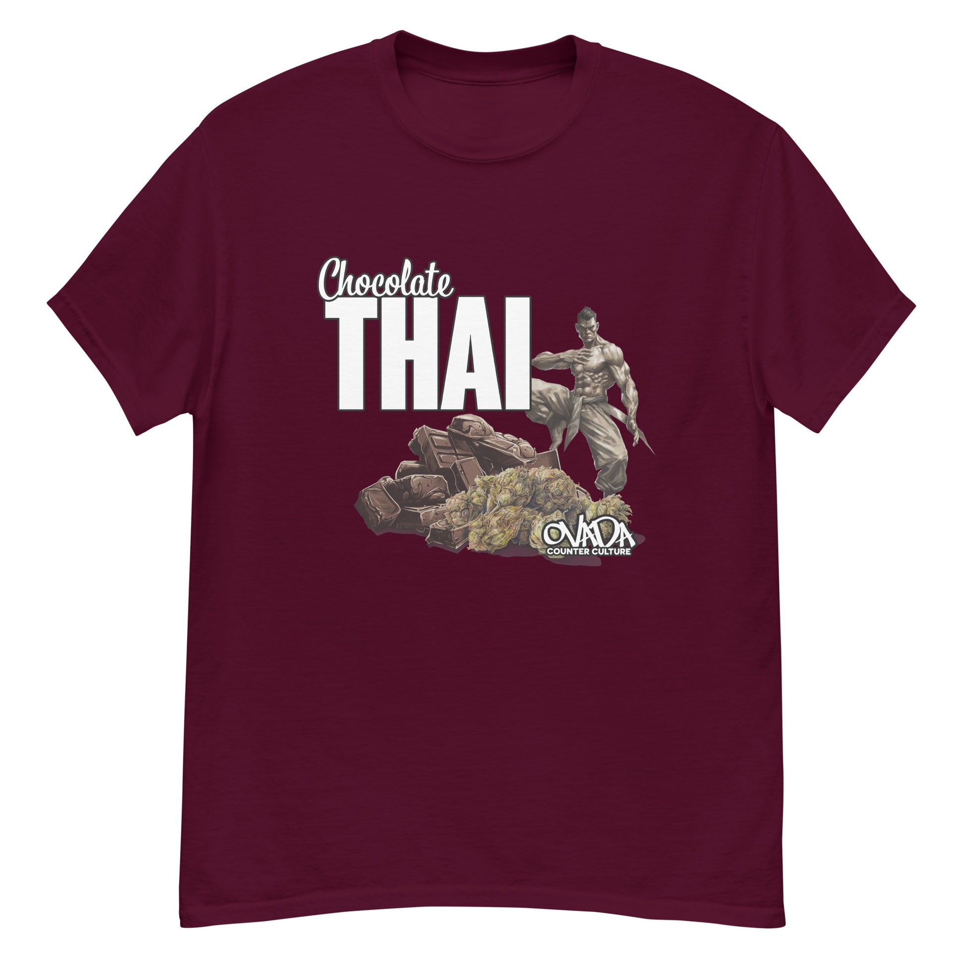 A maroon cotton graphic t-shirt with the words Chocolate Thai. A cartoon depiction of a Muay Thai Fighter is standing on a pile of chocolates, with marijuana buds in front of it. 