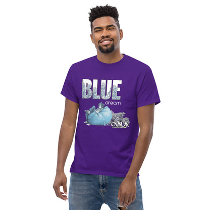 A man in a purple cotton graphic t-shirt with the words Blue Dream. A monochromatic blue cartoon depiction of a stoner passed out in a bean back with marijuana buds behind him. Weed